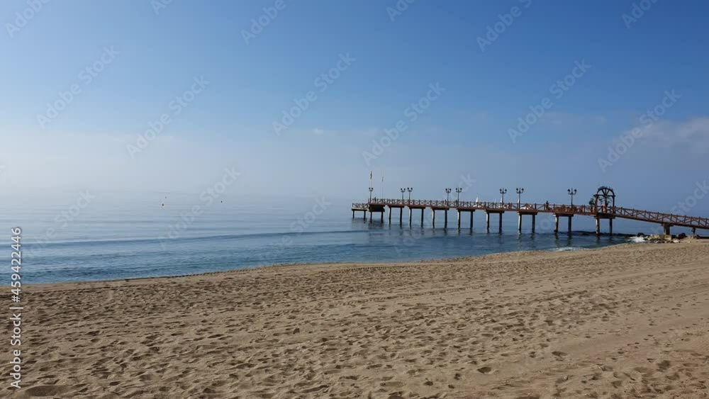 Relax view of mediterranean sea and the pier from the empty beach Relax view of mediterranean sea and the pier from the empty beach