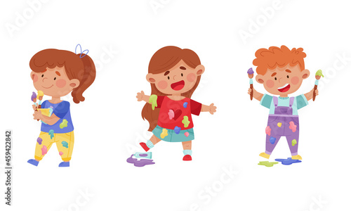 Creative kids in stained clothes holding paint brushes set cartoon vector illustration