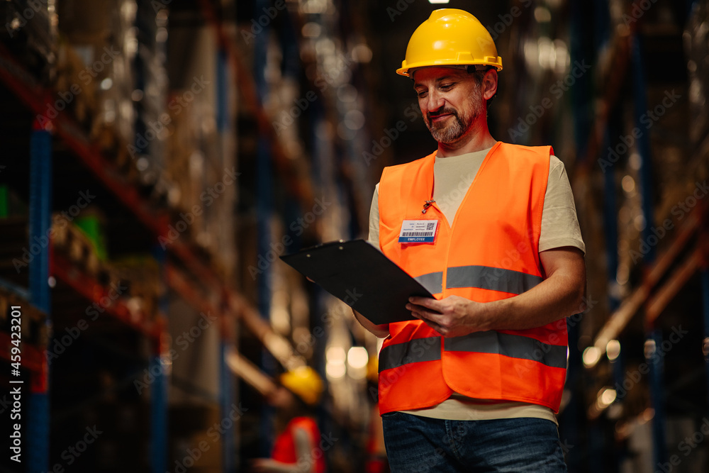 Male worker reading checklist Male worker reading checklist