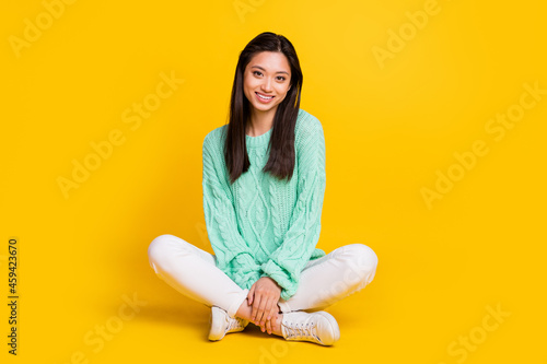 Full body photo of pretty cute nice woman sit floor good mood smile isolated on shine yellow color background