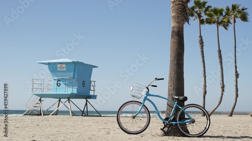 Photography Blue bicycle, cruiser bike by sandy ocean beach, pacific coast near Oceanside pier, California USA
