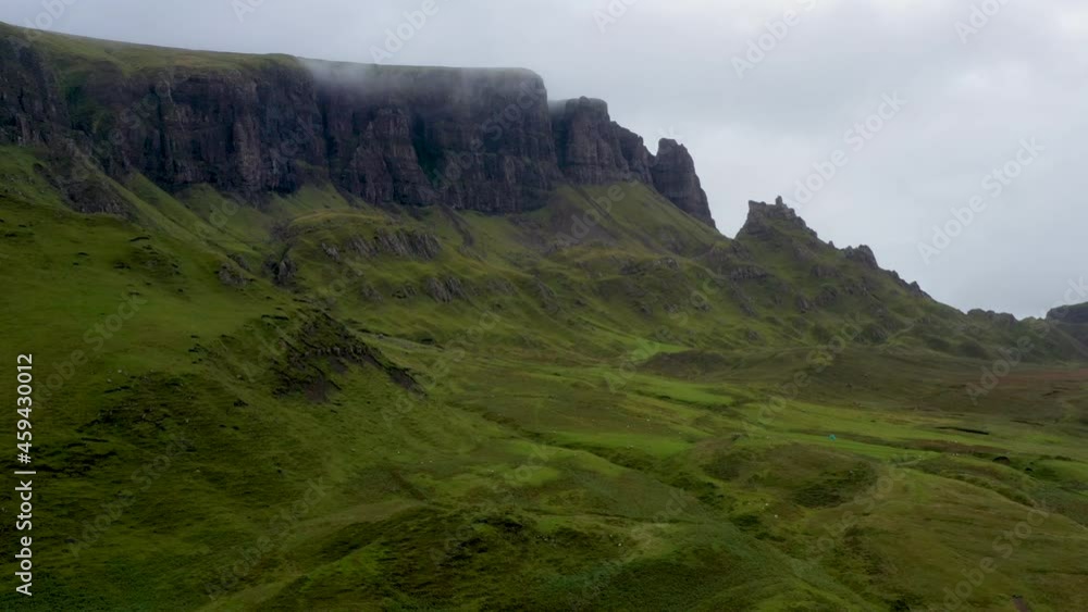 Revealing drone shot of Quiraing the landslip on the eastern face of Meall na Suiramach in Scotland