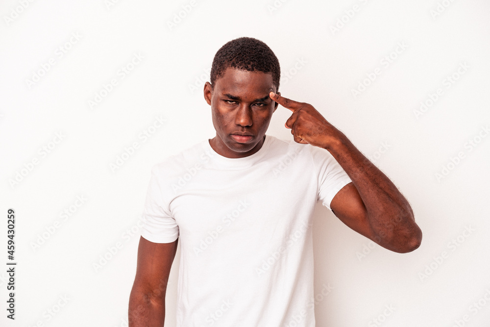Young African American man isolated on white background pointing temple with finger, thinking, focused on a task. Young African American man isolated on white background pointing temple with finger, thinking, focused on a task.