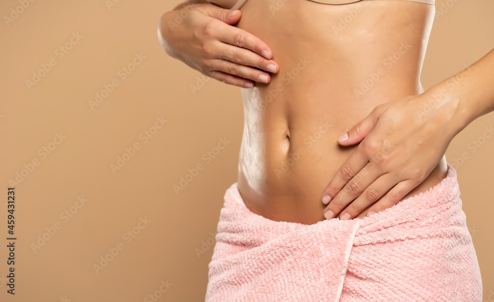 Slim woman massaging abdomen