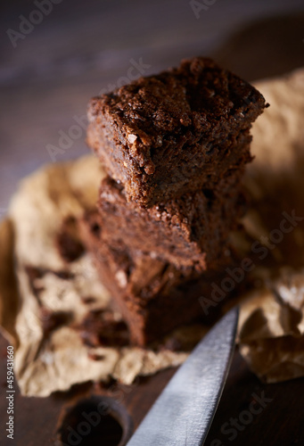 Freshly baked tasty chocolate brownies on a wooden background