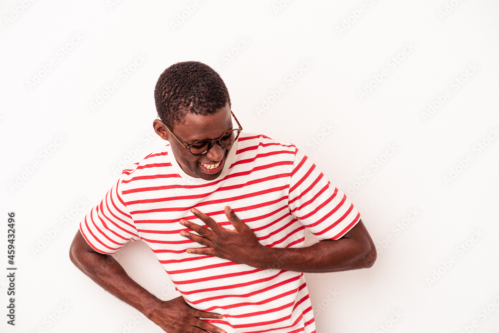 Young African American man isolated on white background laughing keeping hands on heart, concept of happiness. Young African American man isolated on white background laughing keeping hands on heart, concept of happiness.
