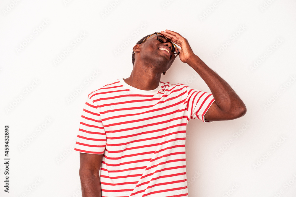 Young African American man isolated on white background laughs joyfully keeping hands on head. Happiness concept. Young African American man isolated on white background laughs joyfully keeping hands on head. Happiness concept.