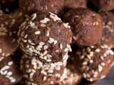 Close-up brown.vegetarian sweets garnished with sesame seeds and carob powder. Energy balls.  Raw food sweets. Proper nutrition.