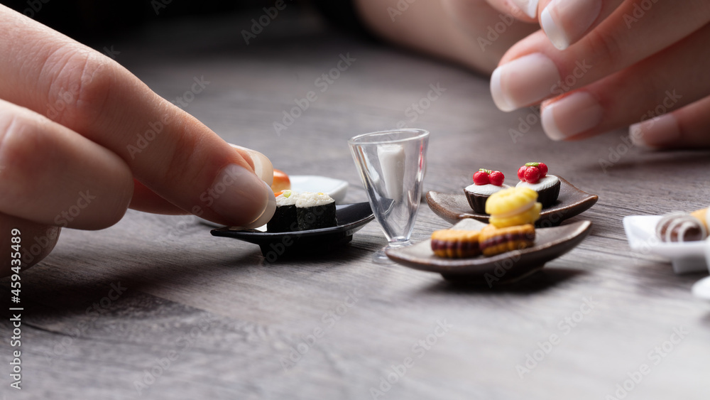female hands on a table with a mini meal female hands on a table with a mini meal