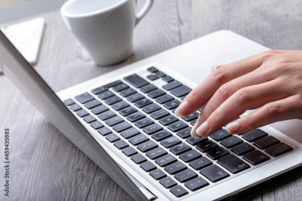 woman hands on laptop keyboard and cup of coffee woman hands on laptop keyboard and cup of coffee