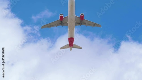 4k Slow motion of an Airbus A320 of the Iberia airline seen with a low angle just after take off in a blue sky photo