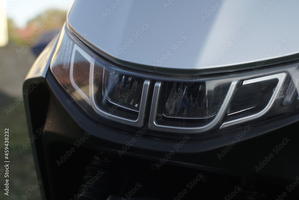 Obraz premium A Headlight Of A Grey Scooter