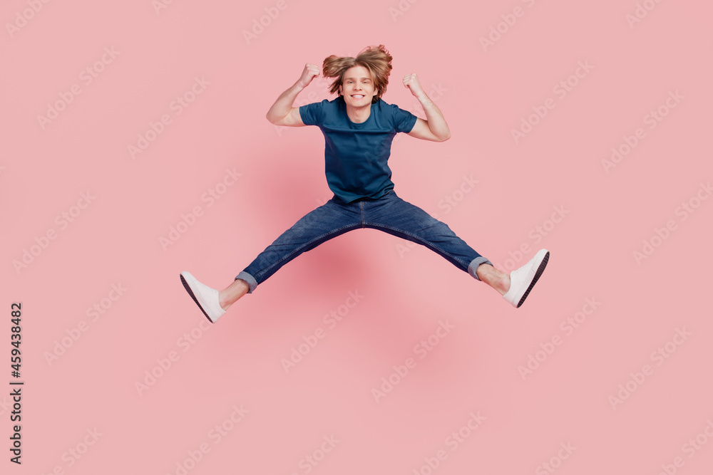 Portrait of funny funky flexible cheerful positive guy jump celebrate victory on pink background Portrait of funny funky flexible cheerful positive guy jump celebrate victory on pink background