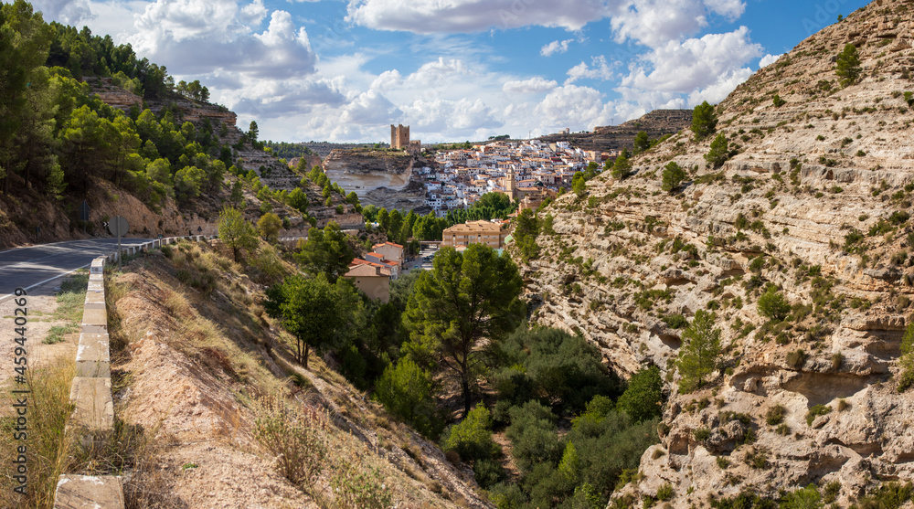 View on Alcala del Jucar, Castilia la Mancha, Spain, its castle towering above the white village.
