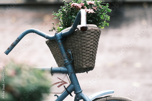 vintage basket with flowers on an old bicycle. parked bicycles. selective focus