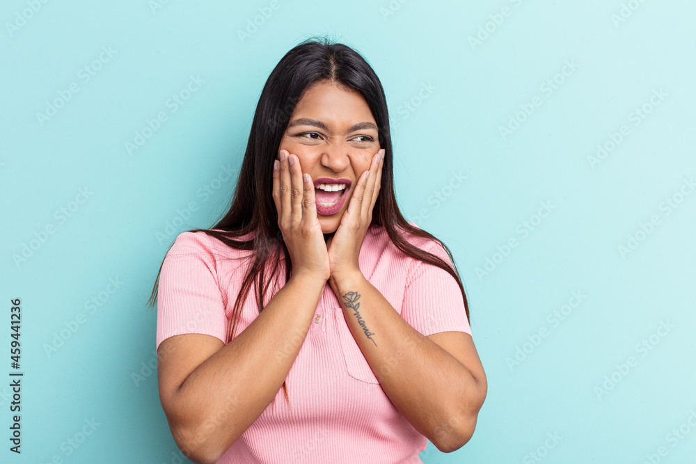 Young Venezuelan woman isolated on blue background scared and afraid. Young Venezuelan woman isolated on blue background scared and afraid.