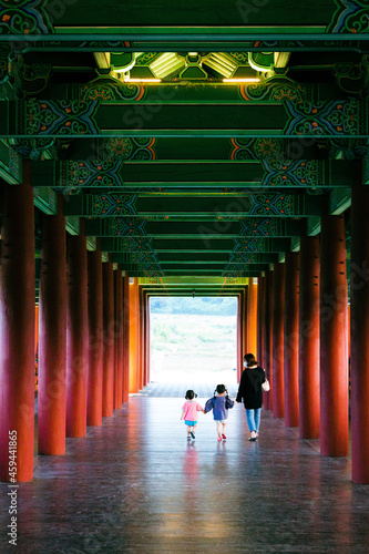 Family crossing the woljeong bridge in Gyeongju, South Korea photo