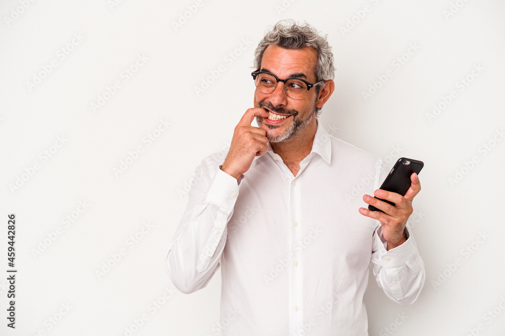 Middle age caucasian business man holding a mobile phone isolated on white background relaxed thinking about something looking at a copy space. Middle age caucasian business man holding a mobile phone isolated on white background relaxed thinking about something looking at a copy space.