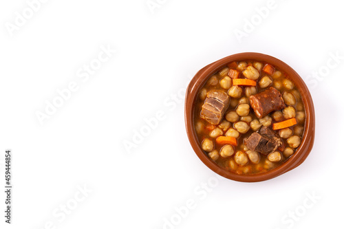 Traditional Spanish cocido madrileño in bowl isolated on white background. Top view. Copy space