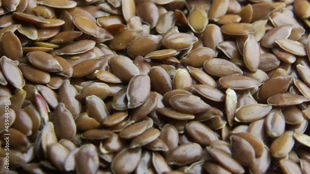 Flax seeds pouring end rotating in slow motion Flax seeds pouring end rotating in slow motion