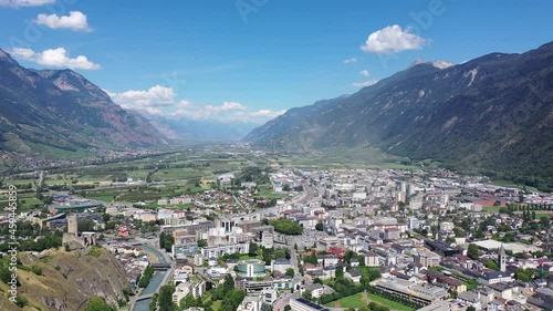 View from drone of houses of commune Martigny and river Drance in mountain valley, Switzerland photo