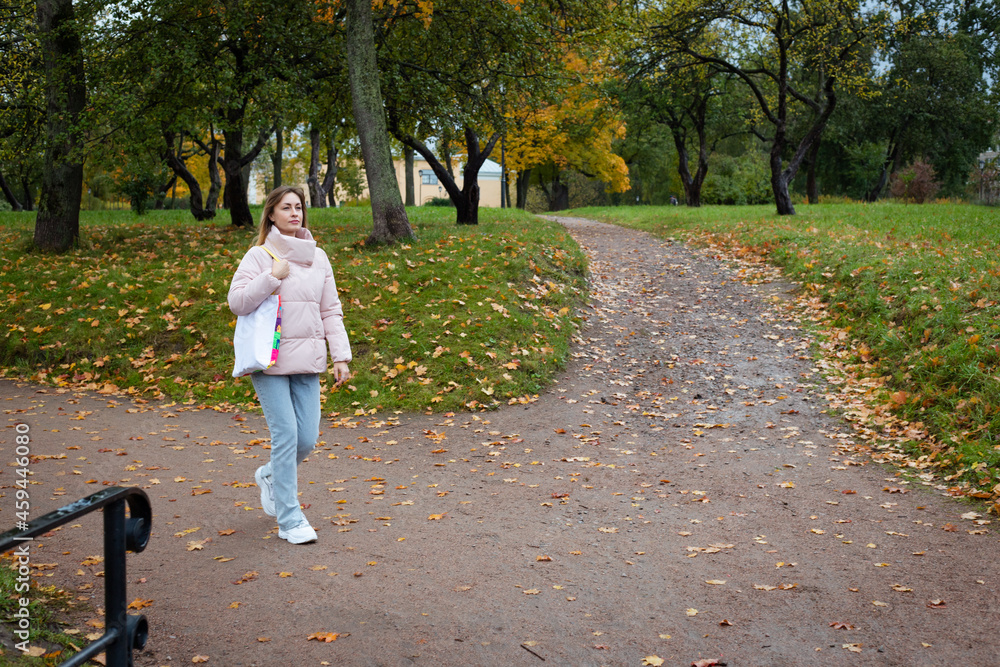 Fototapeta premium eco girl walking in park with coffee cup ang bag