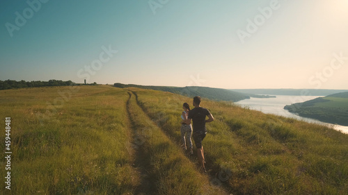 The man and woman running on a beautiful river background