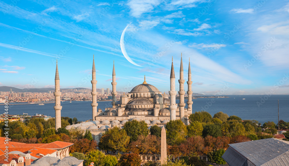 The Blue Mosque with amazing white clouds and crescent (new moon) - Istanbul, Turkey.