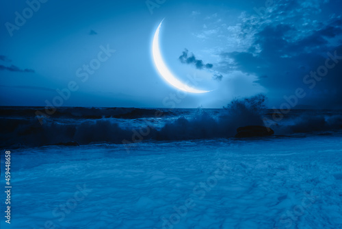 Crescent moon over the sea with lot of stars and nebula at night  Elements of this image furnished by NASA