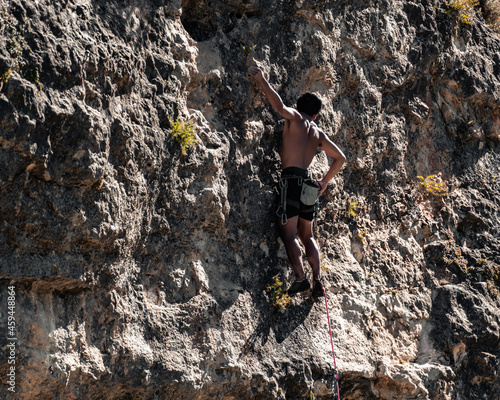 climber in shorts without a shirt with brown and yellow tones