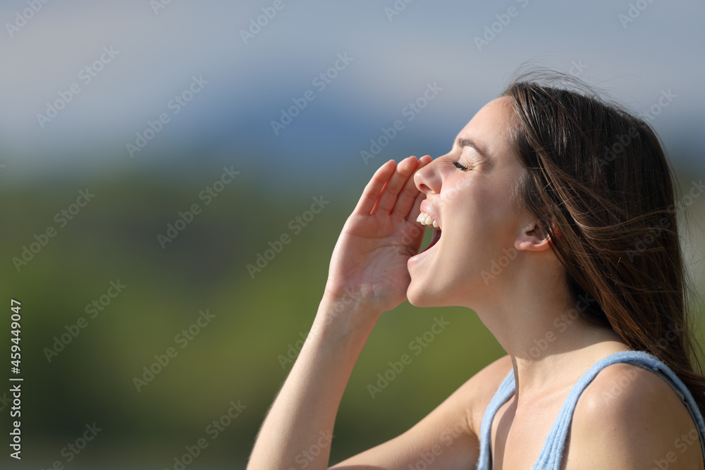 Woman shouting loudly in nature
