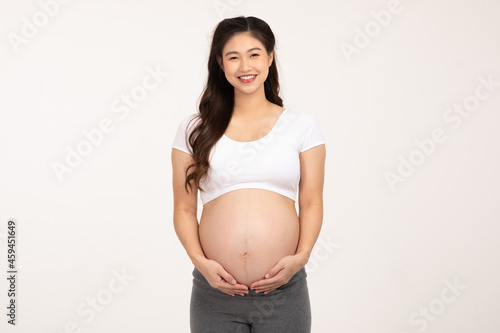 Happy Pregnant Woman standing smile and stroking big belly with love isolated on white background,Pregnancy of young woman enjoy with future life,Motherhood and Pregnant Concept