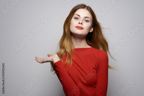 beautiful woman in red dress posing luxury hand gesture isolated background
