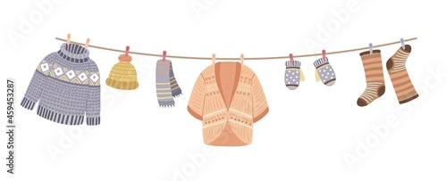 Knitted clothes on rope. Knit, wool thread cardigan and sweater. Knitting accessories, mittens and warm socks vector banner