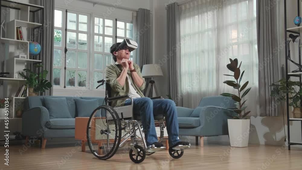Scary Asian Man Sitting In A Wheelchair While Wearing Virtual Reality Goggles Watching Horror Movie At Home
Scary Asian Man Sitting In A Wheelchair While Wearing Virtual Reality Goggles Watching Horror Movie At Home