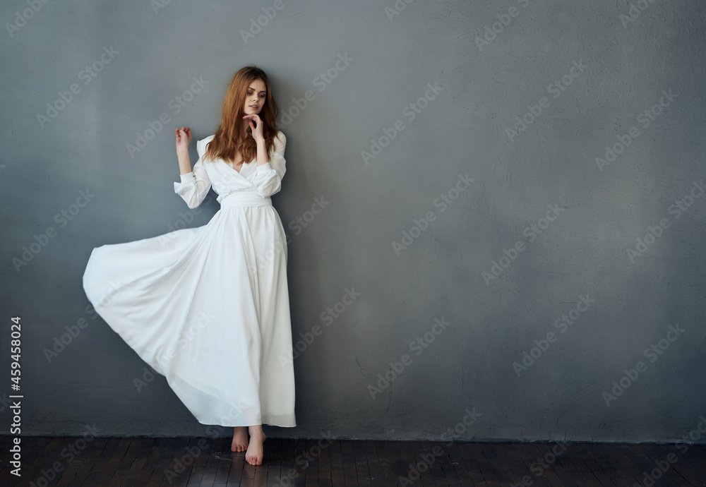 Woman in white dress dance posing isolated background Woman in white dress dance posing isolated background