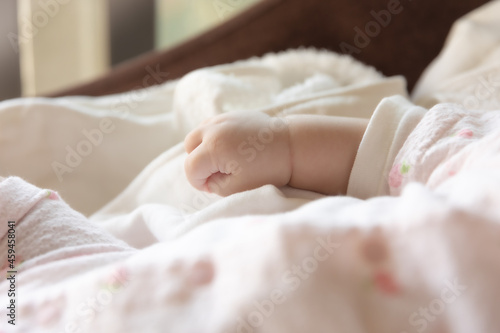 Baby's tiny hand in the morning. Asian girl