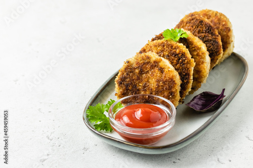 Chicken rissoles with ketchup. Space for text. photo