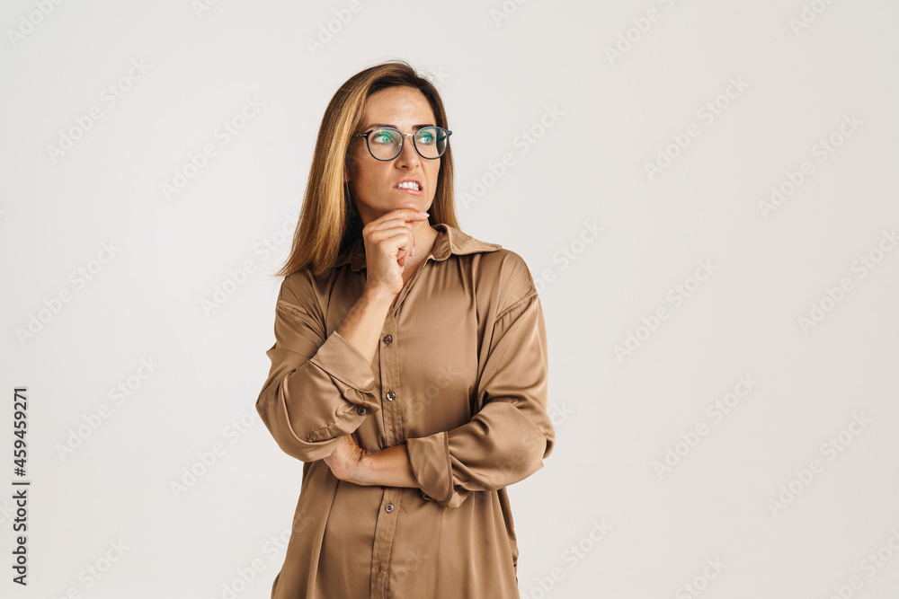European ginger woman in eyeglasses frowning and looking aside European ginger woman in eyeglasses frowning and looking aside