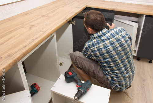 Wallpaper Mural Furniture assembler assembles modern kitchen furniture in a private home Torontodigital.ca