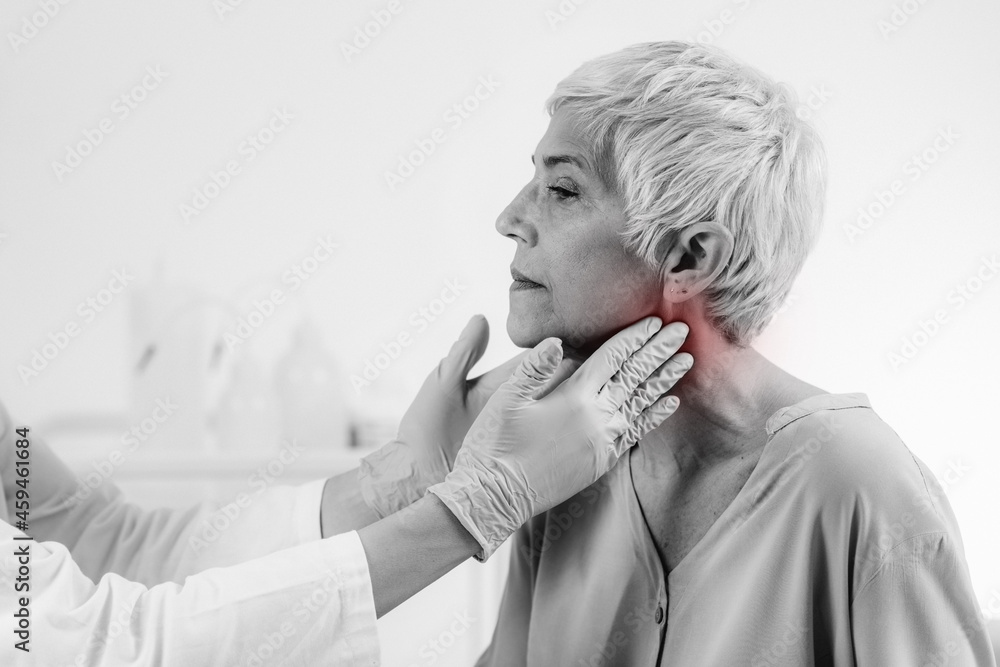 Doctor Examining a Senior Woman with Thyroid Gland Disease Symptoms Doctor Examining a Senior Woman with Thyroid Gland Disease Symptoms