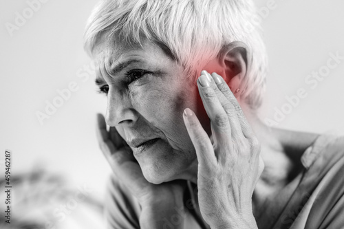 Senior Woman Suffering From Tinnitus photo