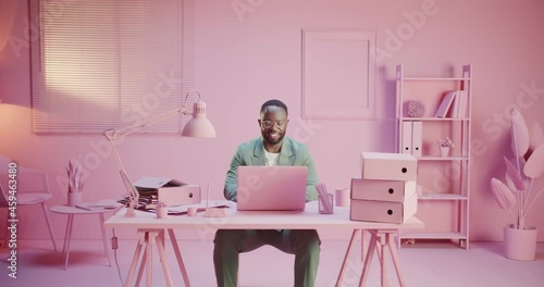 Black happy startupper business man or startup creator is smiling happy at work office with monochrome design working hard in pink pastel room studio monocolor creative office with monochrome design
