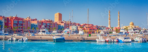 HURGHADA, EGYPT - September 22, 2021 : Marina with tourist boats on Red Sea in sunny day, view from the sea. photo