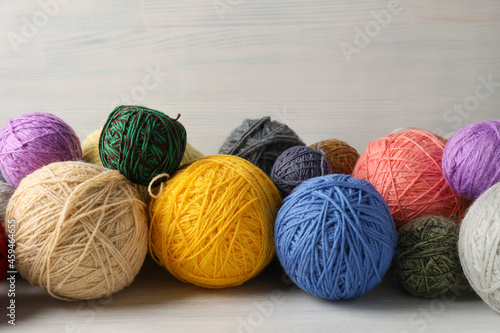 Balls of yarn on white wooden background