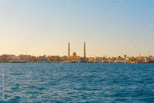 HURGHADA, EGYPT - September 22, 2021 : Mosque El Mina Masjid and the marina with the ships in Hurghada in sunny day, view from the sea.