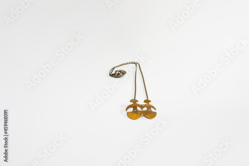 chain necklace with metal human figures on the ends. isolated white background