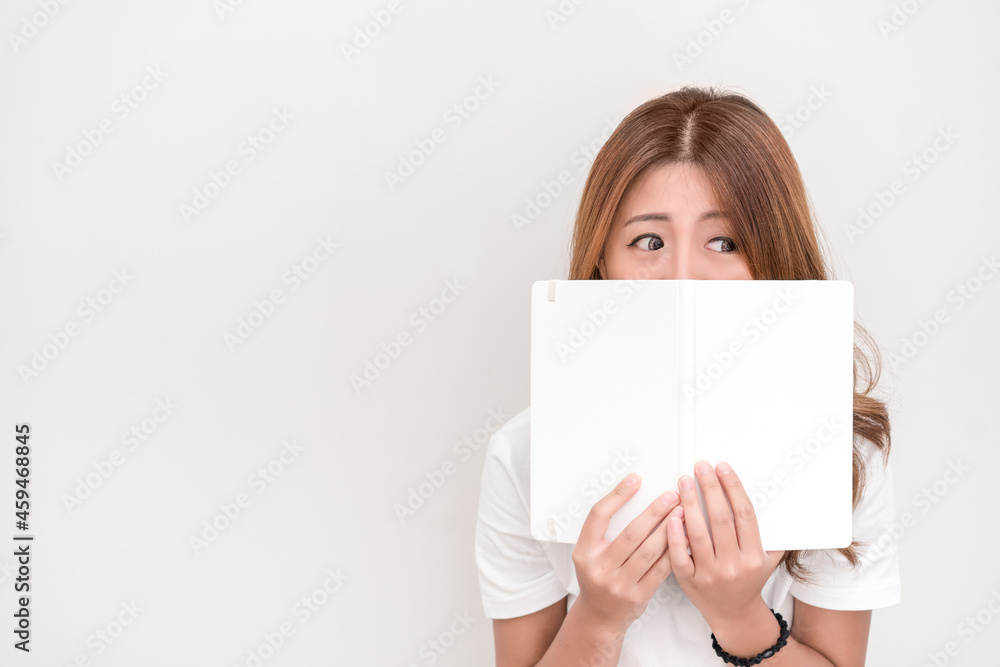Young attractive asian student holding books in her arm on white background. School girl with a books to read for homework. Young attractive asian student holding books in her arm on white background. School girl with a books to read for homework.