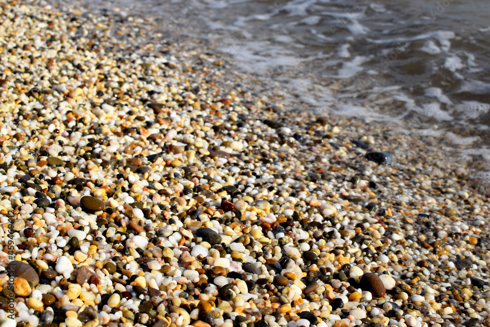 Natural texture background, colorful sea stones in water, top view Natural texture background, colorful sea stones in water, top view