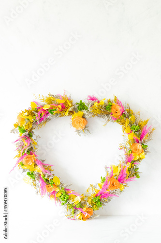 Colorful heart shaped flower arrangement with white background